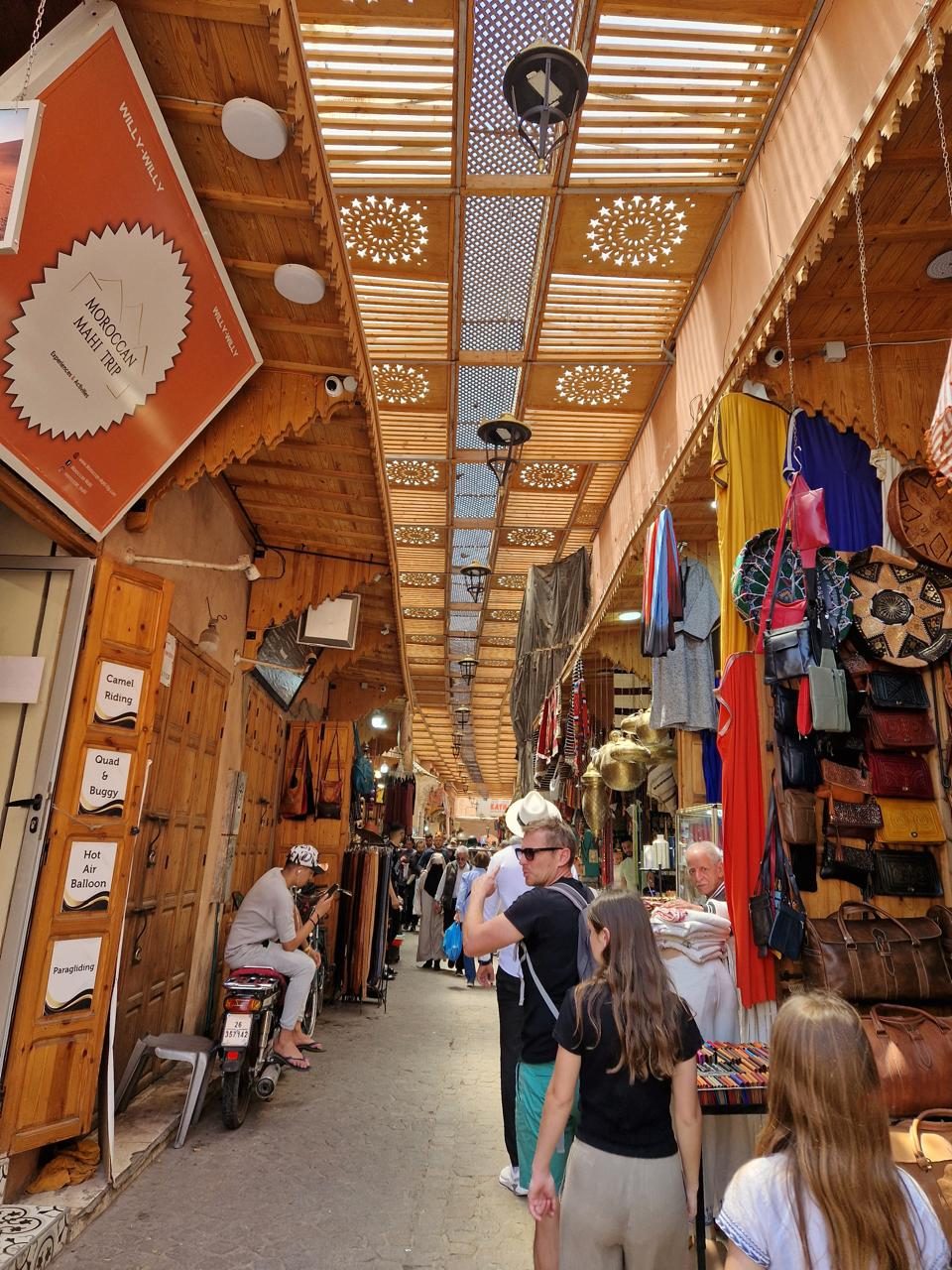 A covered souk alley lined with leather goods and stalls