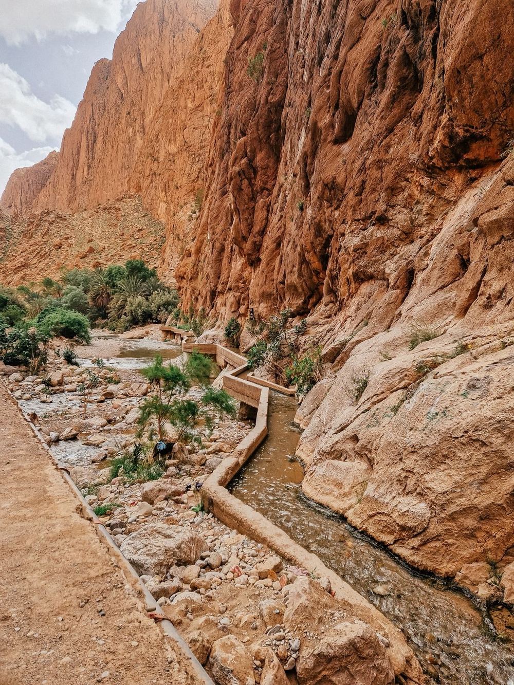 A walkway through the red canyon walls of Todra Gorge